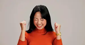 Shock Prints: Asian woman, fist and celebration in studio