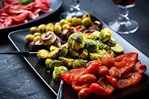 Vegetables Prints: Assortment of appetizers and tapas with red wine on black background