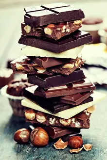 Ingredient Prints: An assortment of white, dark, and milk chocolate with nuts - on wooden board