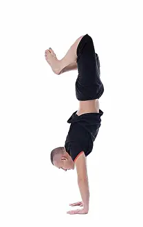 Biceps Prints: Athletic man doing handstand, isolated on white background