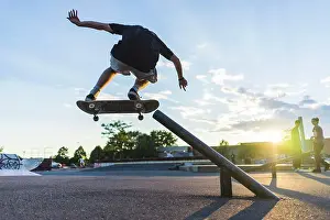 Skateboard Prints: Athletic teenage skateboarder doing a grind