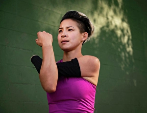 Disability Prints: Athletic woman with amputated hand stretching arm