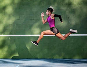 Disability Prints: Athletic woman with prosthetic arm running against wall
