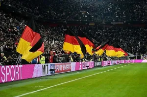 North Rhine Westphalia Prints: Atmospheric flag wavers with German flag in front of the start of the football match