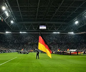 North Rhine Westphalia Prints: Atmospheric flag wavers with German flag in front of the start of the football match