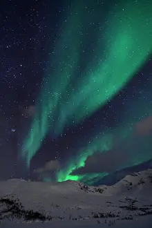 At Night Prints: Aurora Borealis over the mountains near Tromsø, Norway