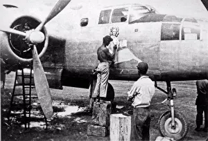 Aviation Prints: Australia: c. 1943 A 5th AAF airman artist painting a pin-up on the nose of a B-25 bomber of the 80th Bomber Group