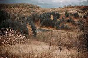 Mystery Prints: autumn hills with colorful trees and lake under stormy sky