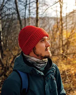 Pensive Prints: Autumn portrait of man in red hat with beard in forest