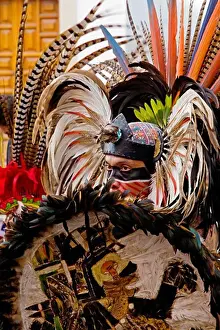 Verticals Prints: An AZTEC DANCER performs in a traditional warrior feathered COSTUME during the CERVANTINO FESTIVAL - GUANAJUATO