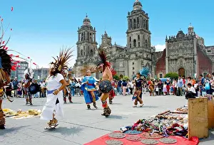 Feather Prints: Aztec performers dance in Zocalo Square in front of Metropolitan Cathedral and the Metropolitan Sagrario in Mexico City