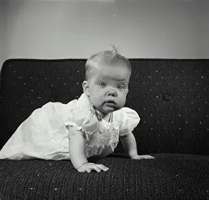 Baby Clothing Prints: Baby girl crawling on a couch