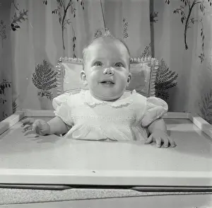 Attention Prints: Baby girl sitting in a high chair
