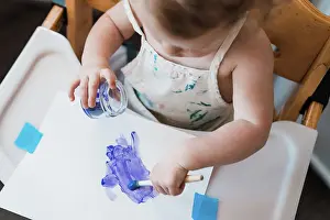 1 2 Years Old Prints: Baby painting an art project with purple paint