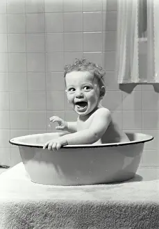 9 12 Months Prints: Baby sitting in a washtub