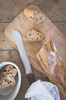 Knife Prints: A baguette is cut on a cutting board with a knife