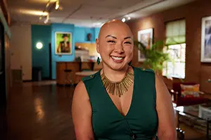 Bald Prints: Bald businesswoman with a bright smile in her creative workspace