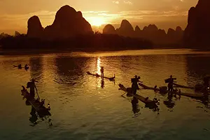 Dramatic Light Prints: Bamboo rafts on the Li River at sunset, Yangshuo, Guangxi Province, China