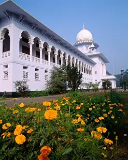 Asian Prints: Bangladesh, Dhaka, Supreme Court Building Exterior Facade With Ornate White Arches And Orange Flowers In Foreground