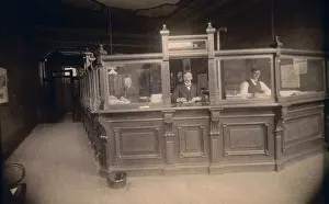 Mature Men Prints: Bank tellers standing behind a bank counter