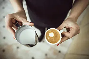 Cafe Prints: Barista holds two cups, with milk and latte Barista holds two cups