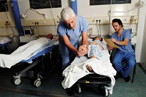 Hospital Ward Prints: Bearded surgeon checking female patient in hospital bed