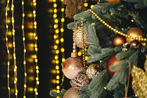 Festive Prints: Beautiful Christmas tree with golden balls decor close up