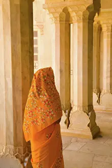 Beautiful graphic arches with colorful Hindu gentle woman posed at Amber Fort temple in Rajasthan Jaipur India (MR)