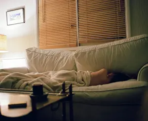 Depressed Prints: Beautiful naked woman sleeps in a blanket on a comfy couch