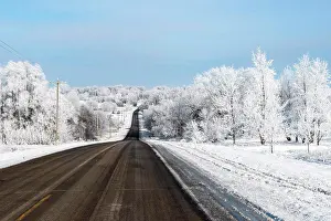 Frosty Prints: Beautiful snowy winter scene along hilly road