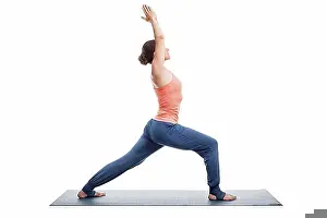 Thirty Prints: Beautiful sporty fit yogini woman practices yoga asana Virabhadrasana 1