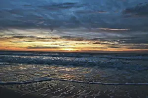 Benelux Prints: Beautiful sunset sky with last rays of light and partial clouds over North Sea ocean on island Texel in the Netherlands