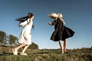 People In Nature Prints: two beautiful twin girls doing style lying in a field at sunset