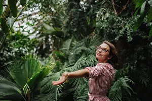 Global Prints: Beautiful woman standing in botanical garden