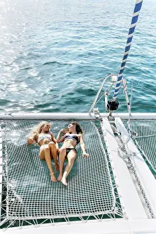 Best Prints: Two beautiful women enjoying a summer day on a sailboat