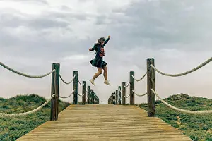 Mystery Prints: Beautiful young female jumping in air above catwalk in zero gravity
