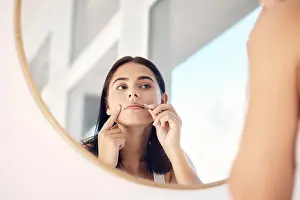 Cleaning Prints: Beauty, mirror and tweezers with a woman in the bathroom of her home for hair removal or skincare