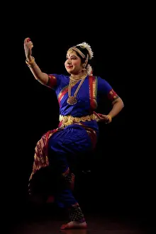Expressions Prints: Bharatnatyam dancer in a saraswati pose during her performance on a dark background