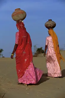 Anthropology Prints: Bhil indigenous women carrying water jugs on their heads, Rajasthan Desert, India