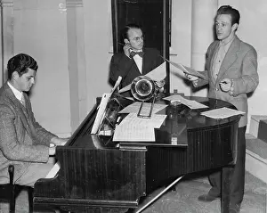 Billy Weston looks pensive and pulls one ear as he listens to Norman Pearson sing a new number