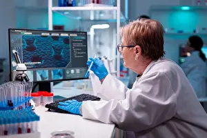 Analysis Prints: Biotechnologist senior scientist researching with test tube
