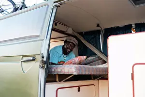 Baby Boomer Prints: black afro american male person inside his camper van, freedom and tra