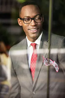 Chic Prints: Black businessman looking out office window