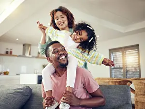 Carry Prints: Black family, father and daughter playing with mother on living room sofa together for fun bonding at home
