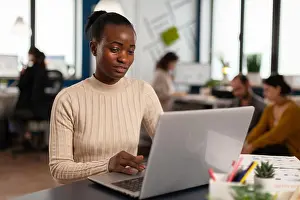 Successful Prints: Black manager reading tasks on laptop