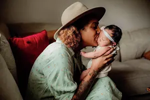 Tattoo Prints: Black mother kissing her daughter on the couch