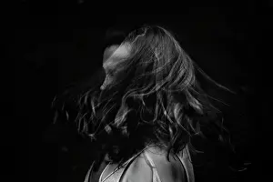 Pensive Prints: Black and white portrait of a female swishing hair