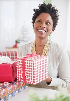 Provided Prints: Black woman holding wrapped gift