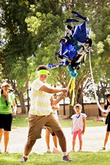 Relish Prints: Blindfolded boy hitting pinata at party