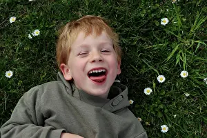 Gradeschooler Prints: The blond boy narrowed his eyes and shows his tongue